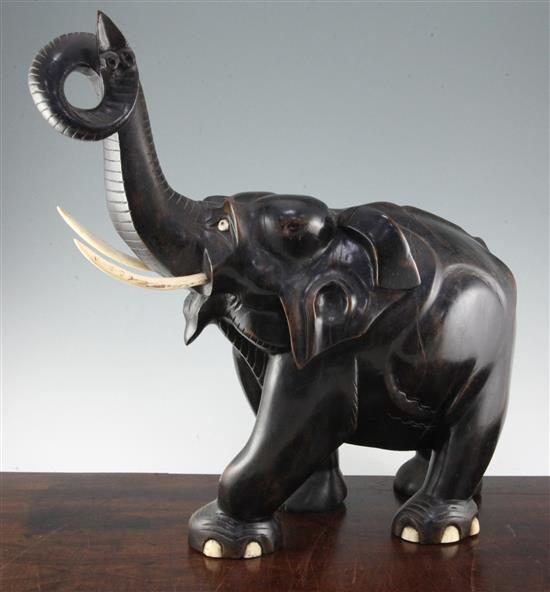 A large Indian ebonised carved hardwood elephant, 21in.